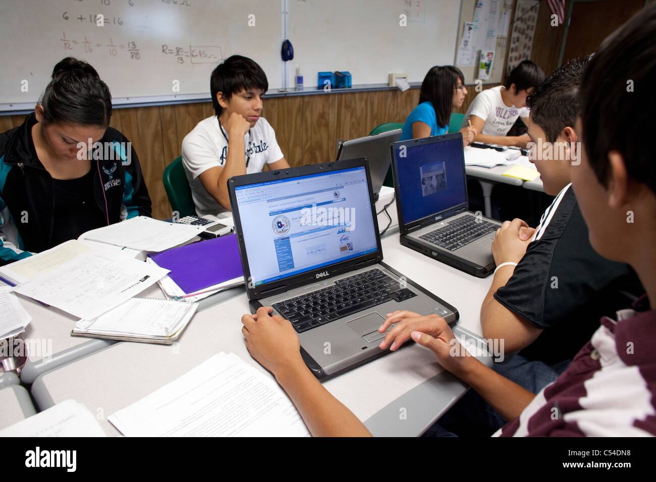 Students use notebooks and laptop computers inside classroom of high school in El Paso, Texas Stock Photo