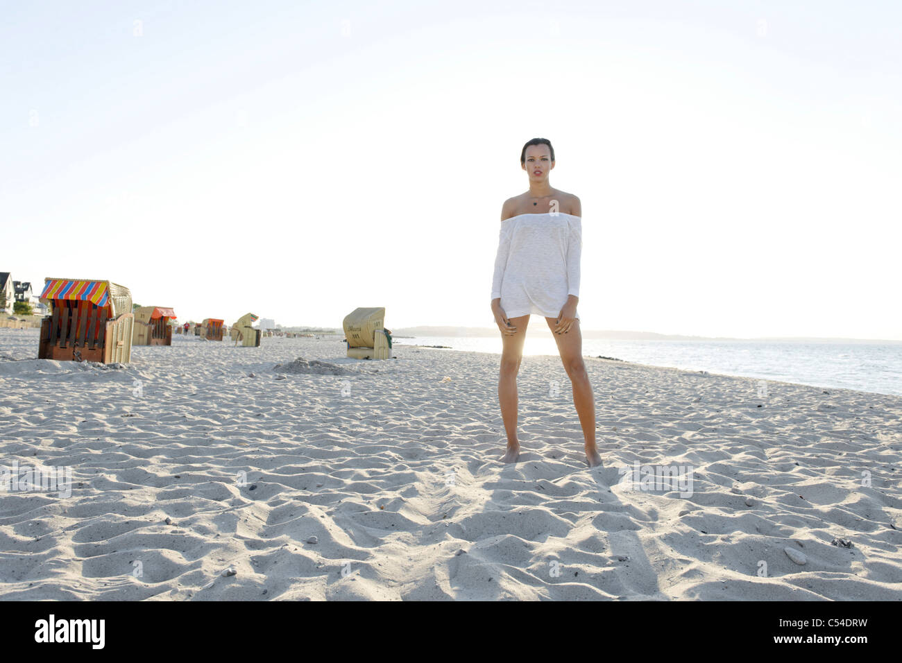 Young woman, 20+, standing on a sandy beach, lifestyle, sensuality, Niendorf at the Baltic Sea, Schleswig-Holstein, Germany Stock Photo