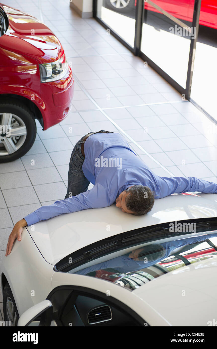 Man lying on hood of car hires stock photography and images Alamy