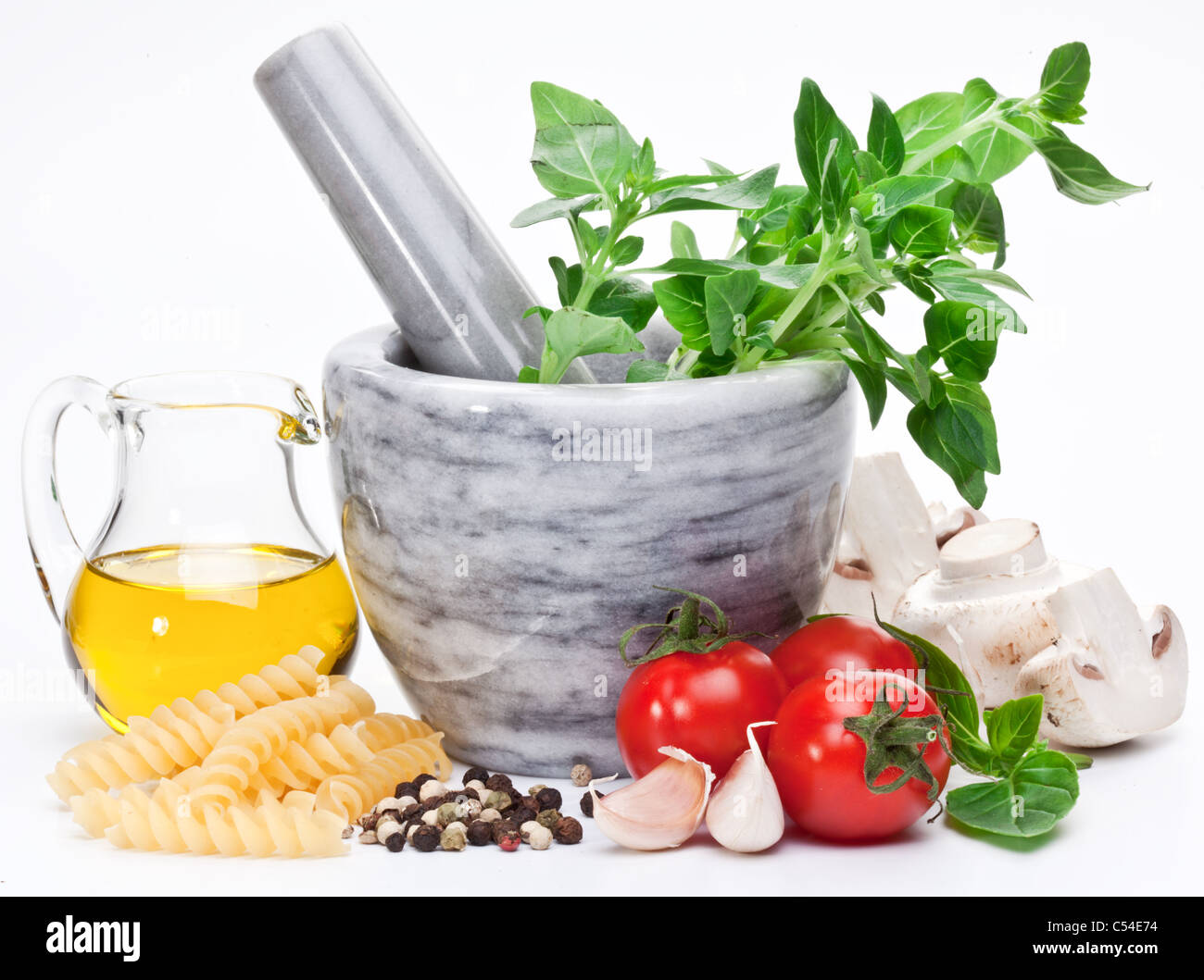 Mortar with pestle and basil herbs and olive oil. Stock Photo