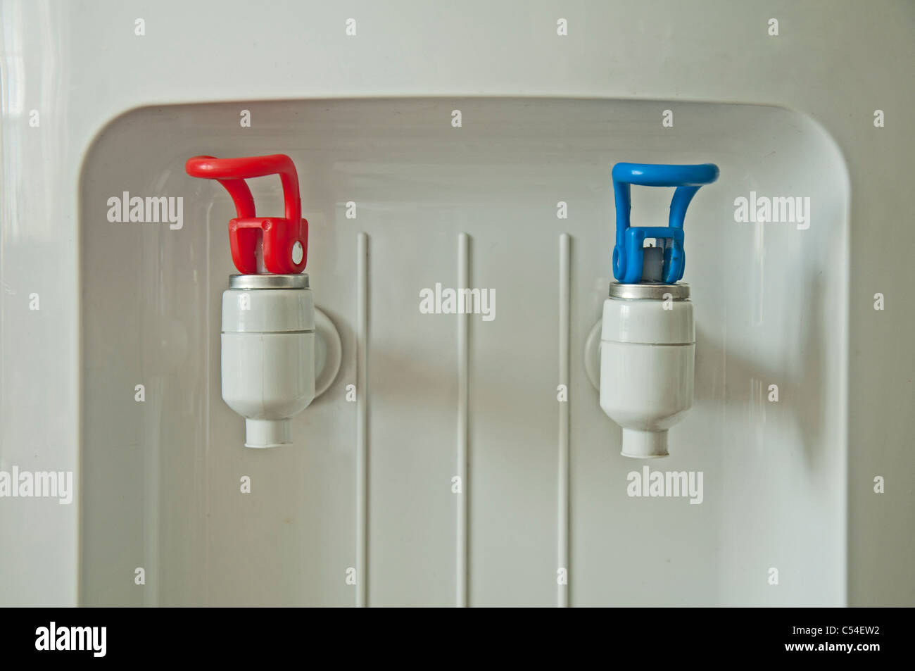 Hot and cold water machine with red and blue spouts Stock Photo