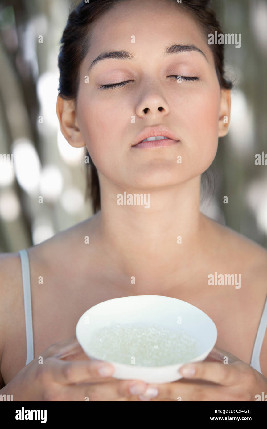 Woman Using Salt Beautiful young woman holding a bowl with bath salt Stock Photo - Alamy
