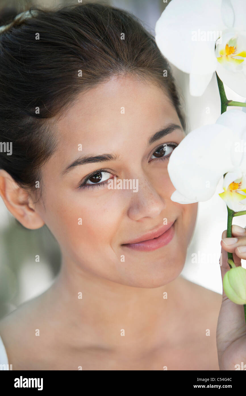 Portrait of a beautiful young woman holding flowers Stock Photo Alamy