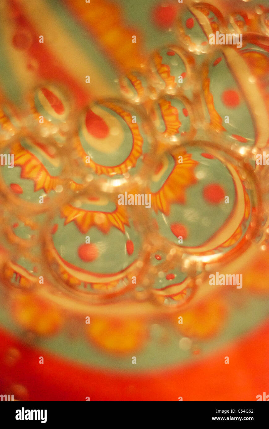 Macro of oil on water on a coloured background Stock Photo