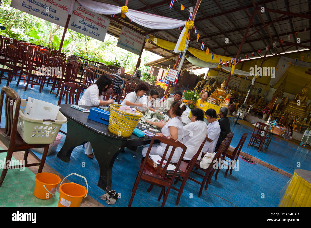 Local people counting charity money. Photo was taken next to the Big Buddha in Phuket, Thailand. Stock Photo