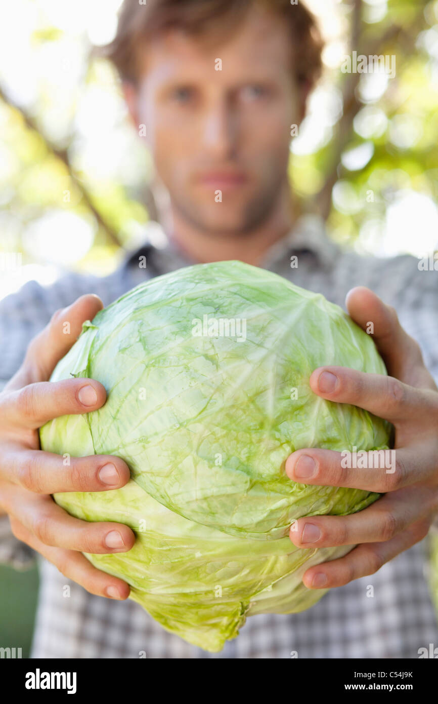 Portrait of a man holding a cabbage Stock Photo Alamy