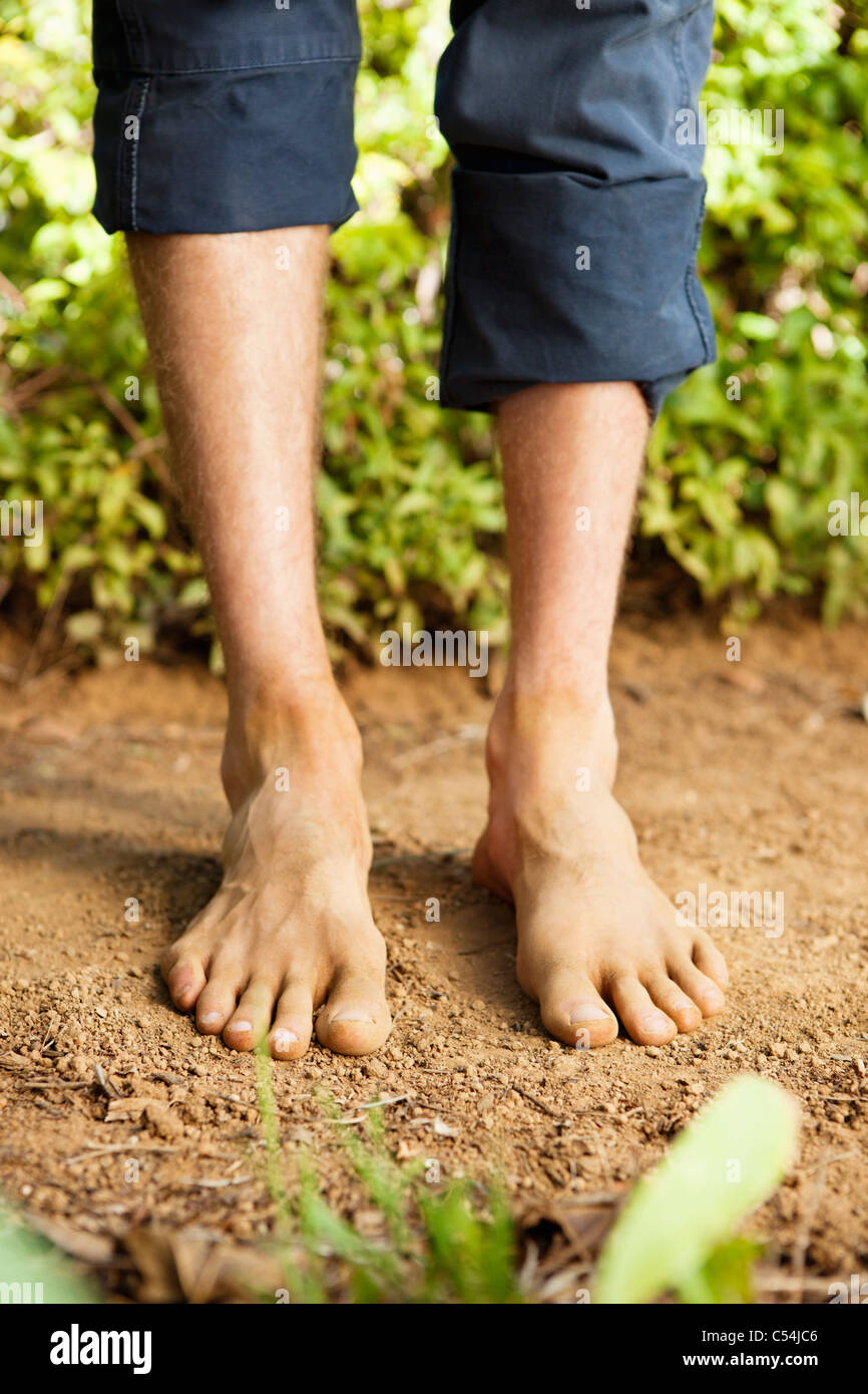 Low section view of a barefooted man Stock Photo - Alamy