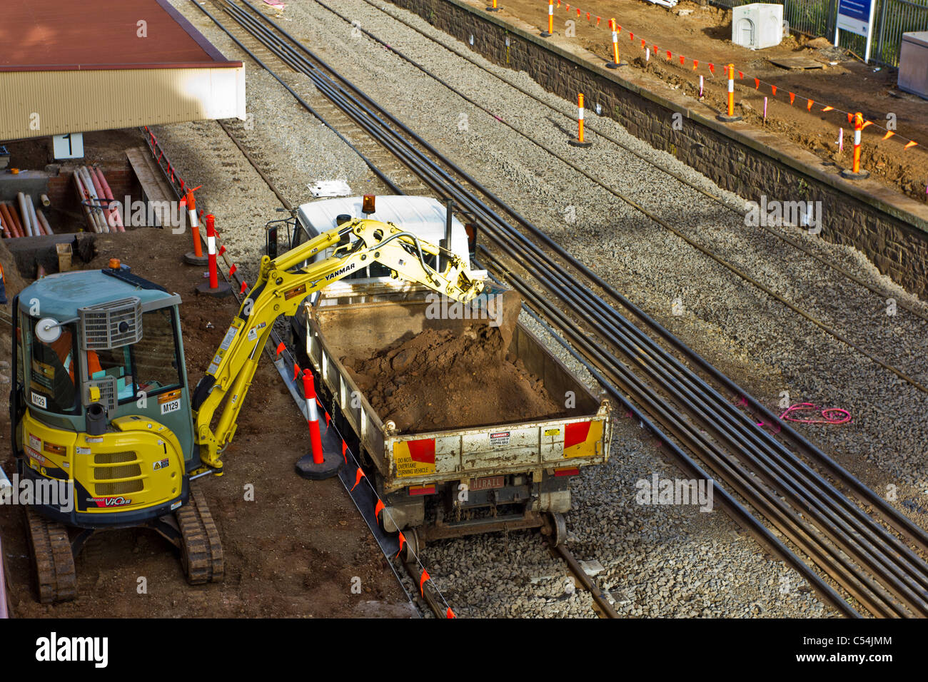 Excavator loading rail track truck Stock Photo