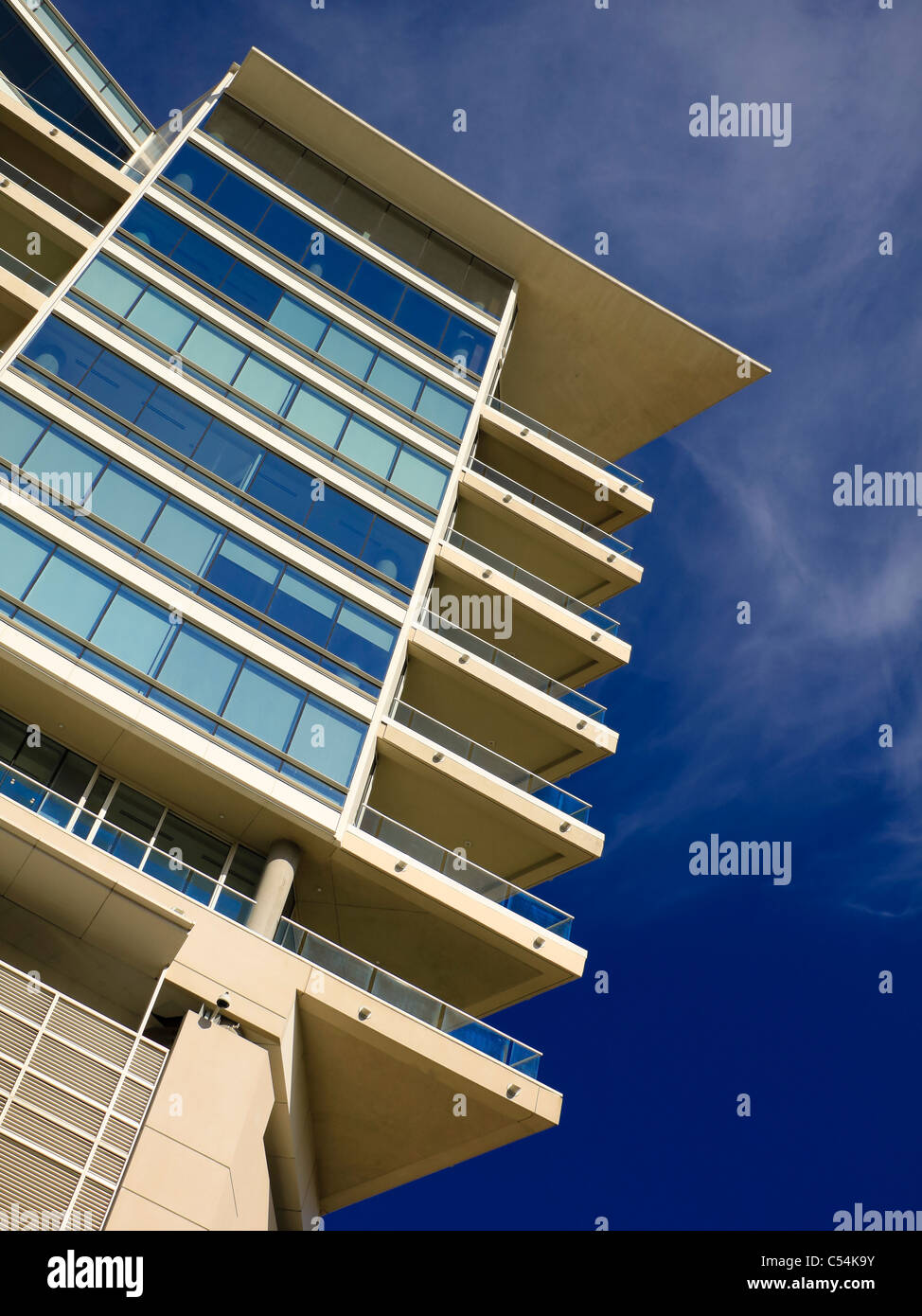 Image showcasing A high-end residential building with glass balconies shoot against a ...