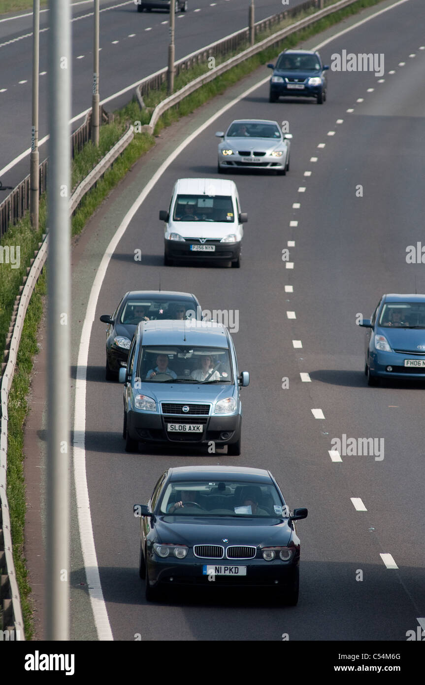 Cars travelling at speed too close to each other in the outside lane of a dual carriageway in England. Stock Photo
