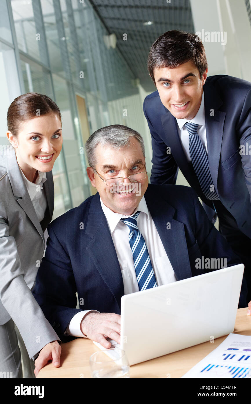 A business team of three looking at camera at workplace Stock Photo - Alamy