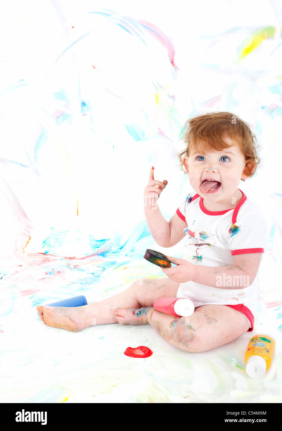 female toddler sat on floor playing with paints Stock Photo - Alamy