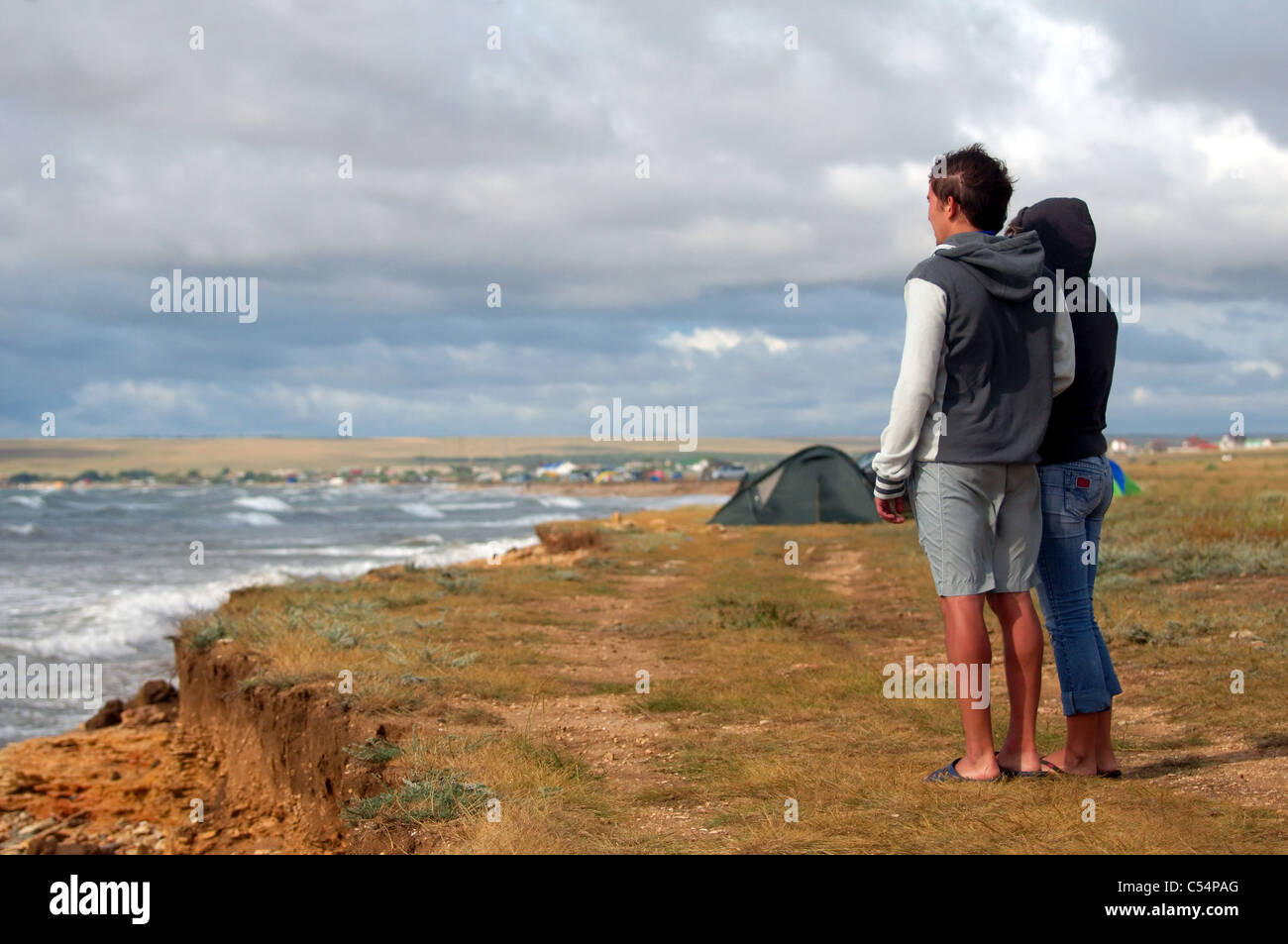 The young pair looks at a stormy sea Stock Photo