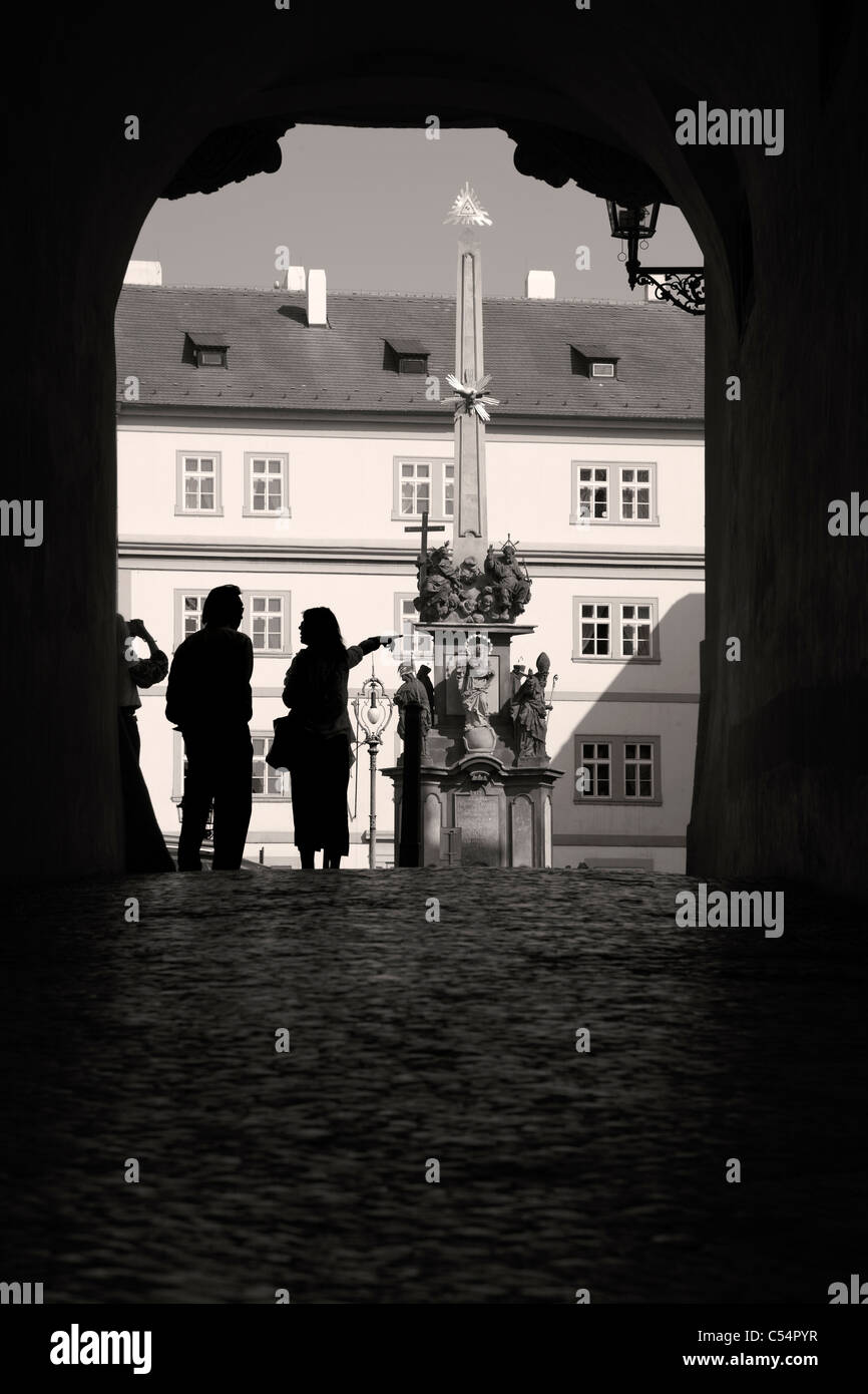 Prague - hl. Trinity column and silhouette of tourists Stock Photo