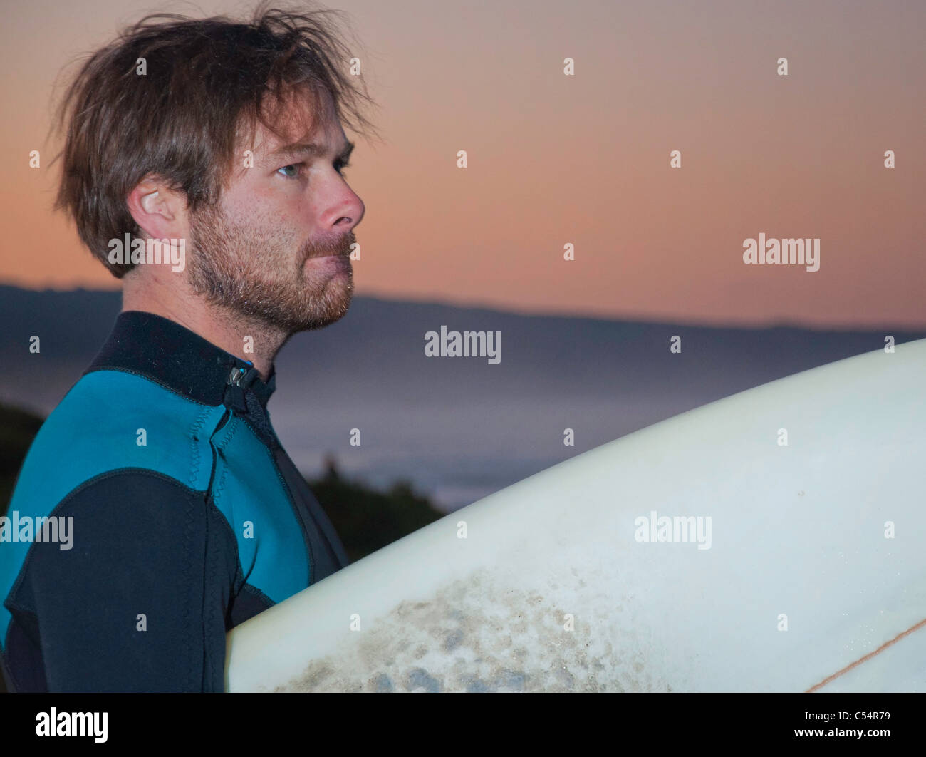 A keen Australian surfer first thing in the morning. Stock Photo