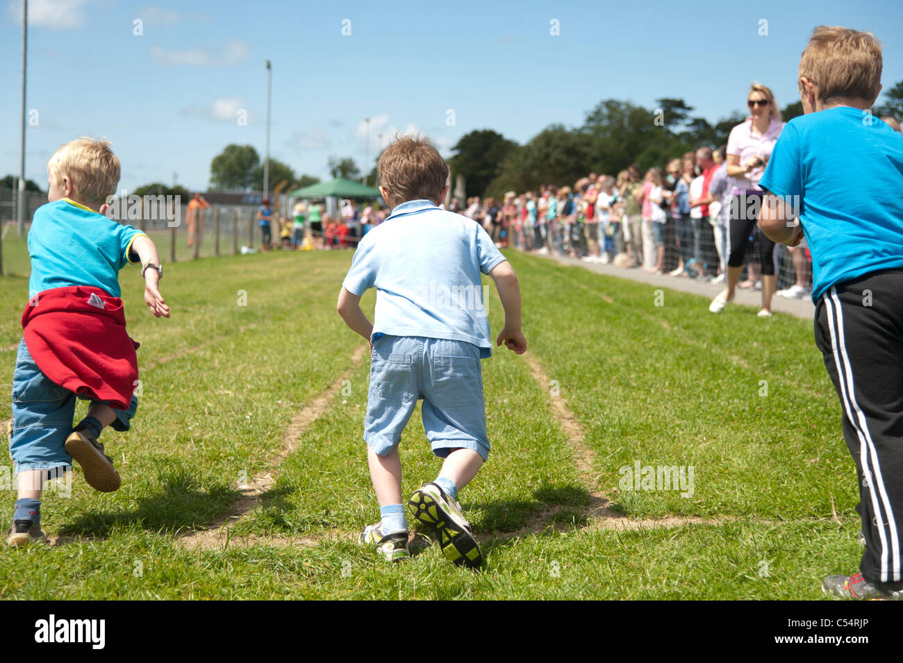 Young small boys racing at the annual School sports day at a small primary school, UK Stock Photo