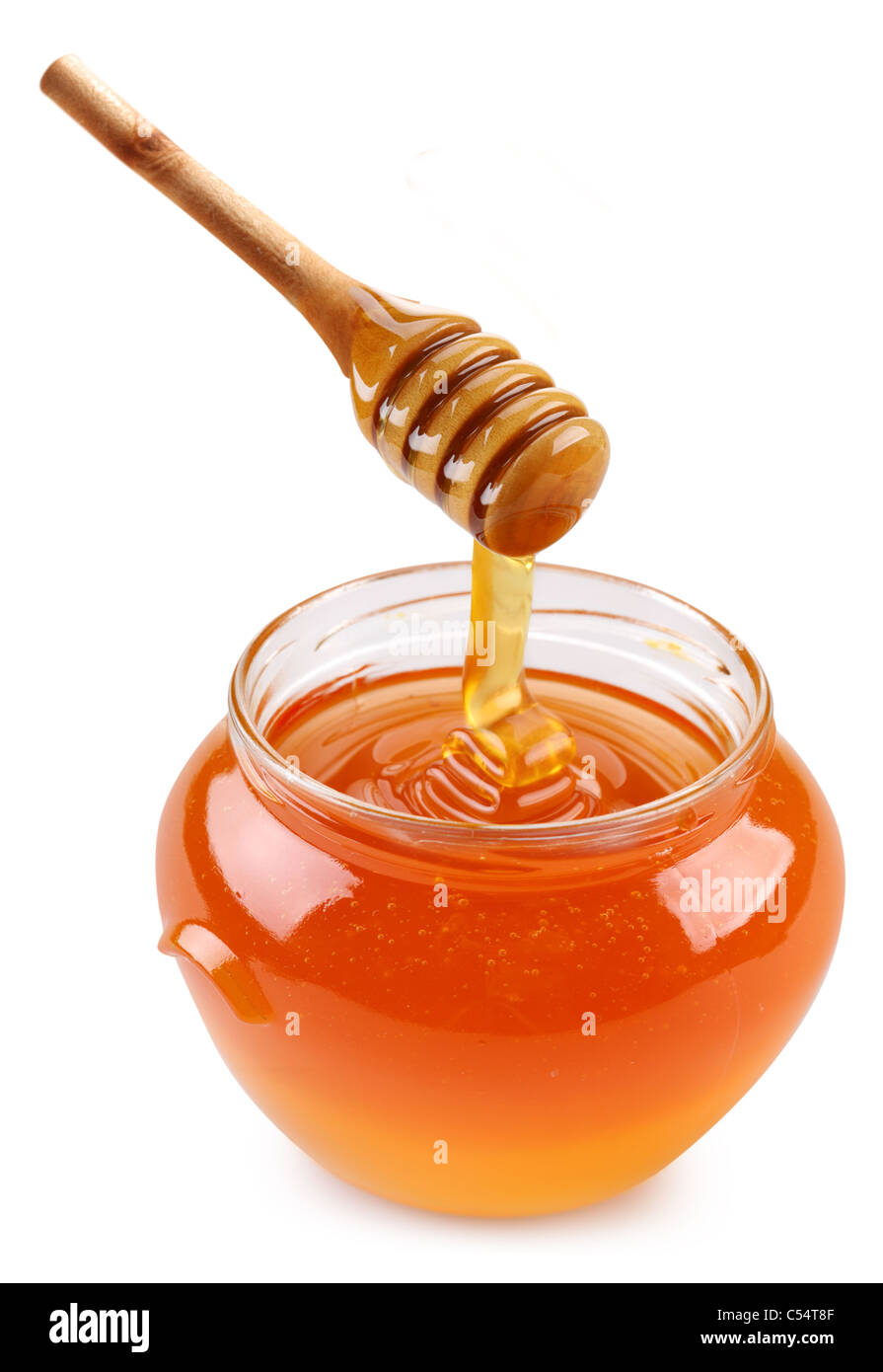 Pot of honey and wooden stick. Isolated on a white background. Stock Photo
