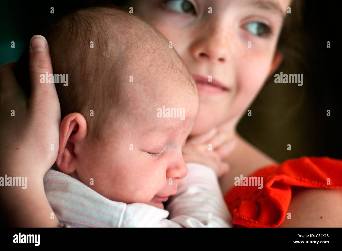 Girl holding baby girl Stock Photo Alamy