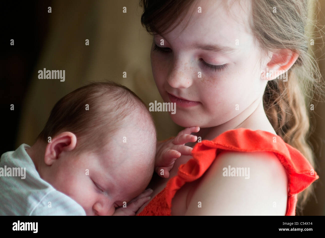 Girl holding baby girl Stock Photo Alamy
