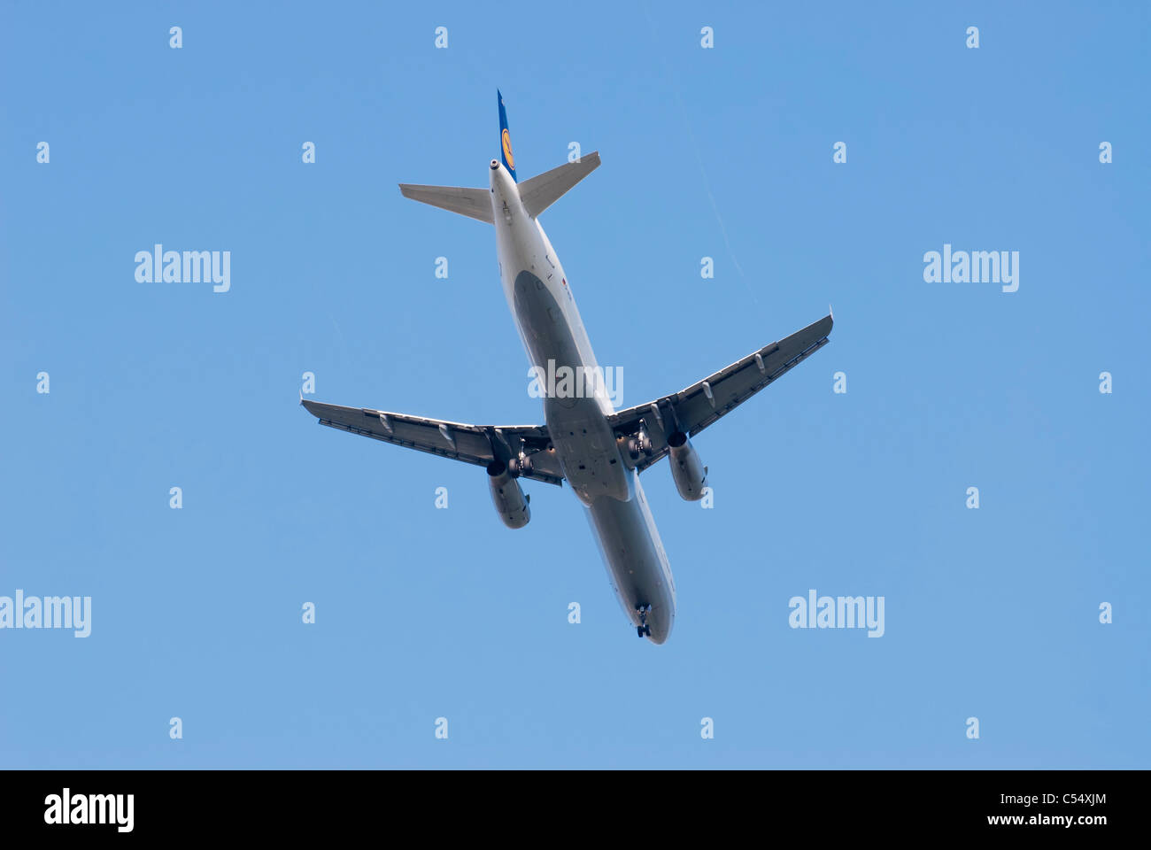 Airplane in blue sky Stock Photo - Alamy