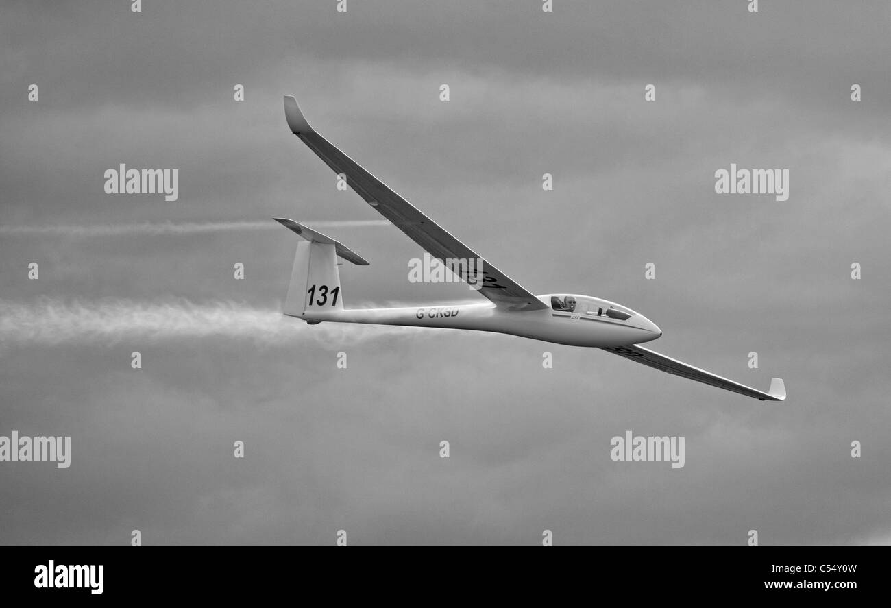 Speeding glider with water vapour trail. Stock Photo