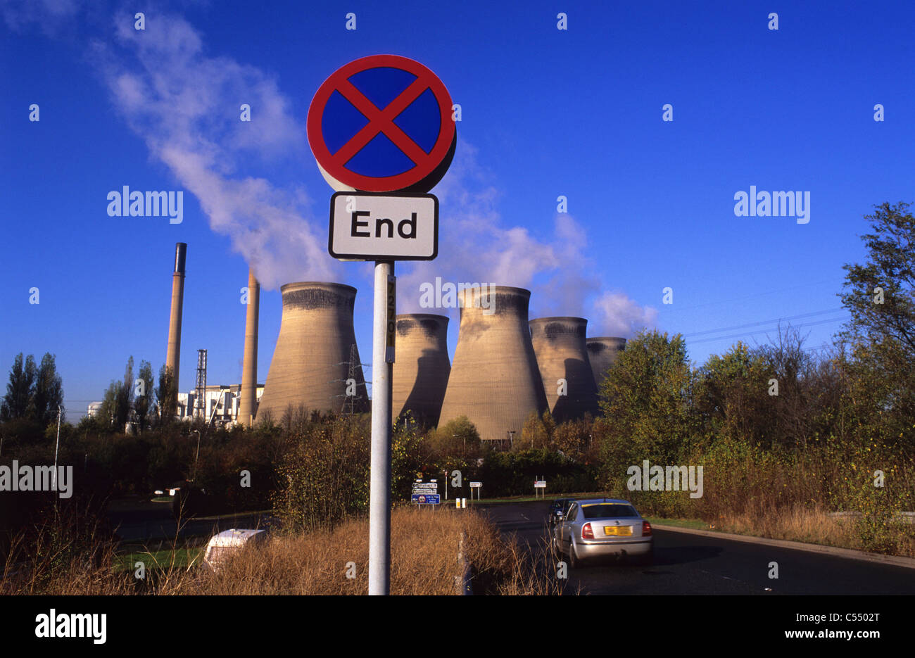 car driver passing end of no stopping area roadsign by Ferrybridge coal powered station Yorkshire UK Stock Photo