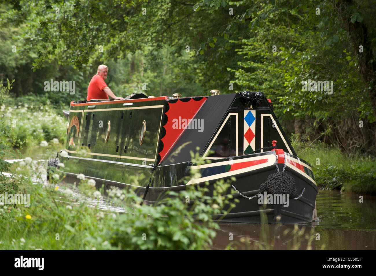 Narrow boat cruising on the Monmouthshire and Brecon Canal near village of Llangattock Powys South Wales UK Stock Photo