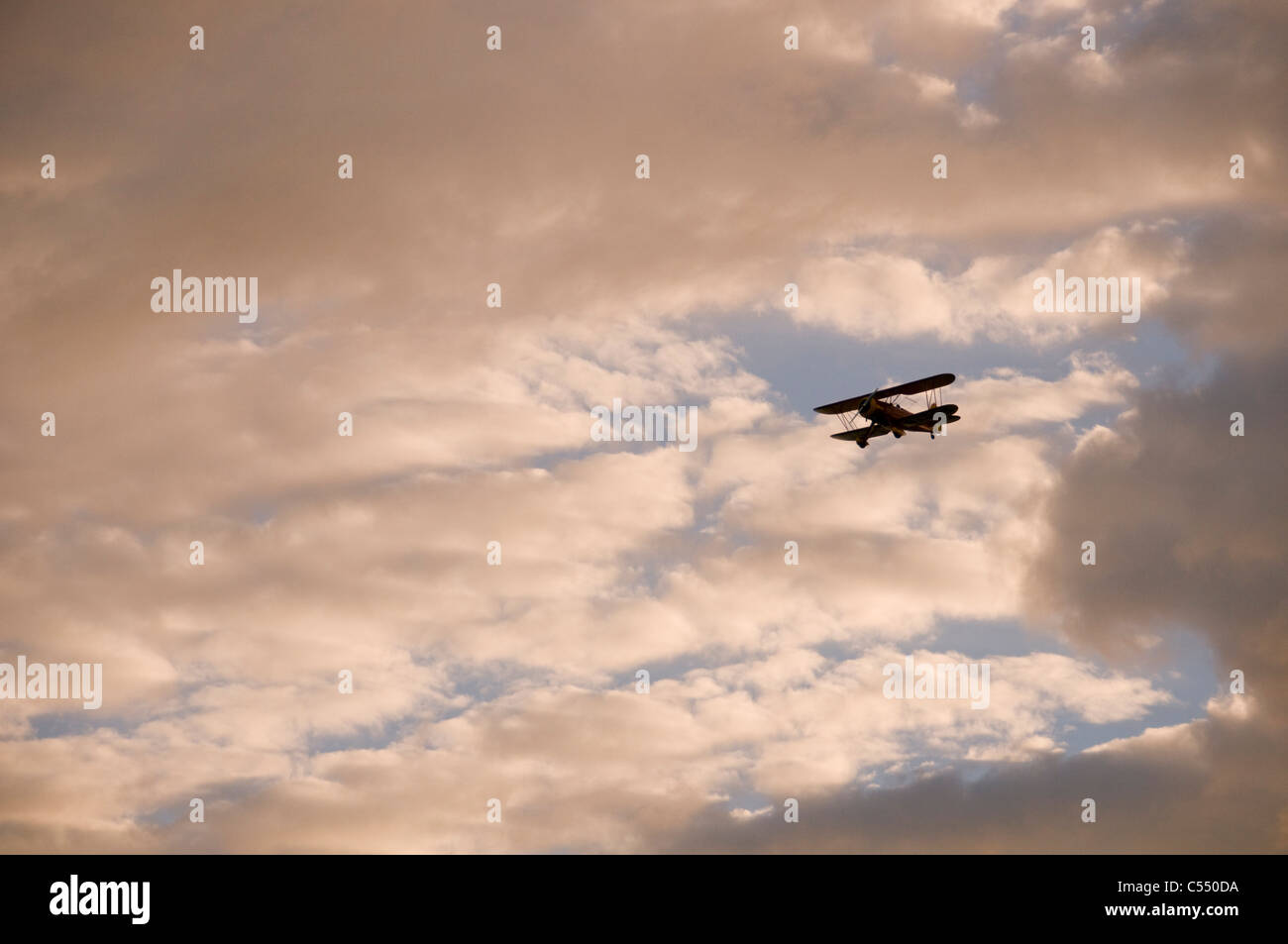 Biplane flying in the sky Stock Photo - Alamy