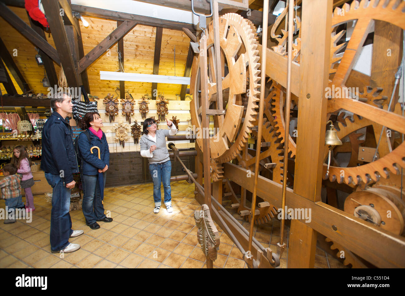 Woman explaining the mechanics of the world's largest cuckoo clock, Schonach in the Schwarzwald, Baden-Wurttemberg, Germany Stock Photo
