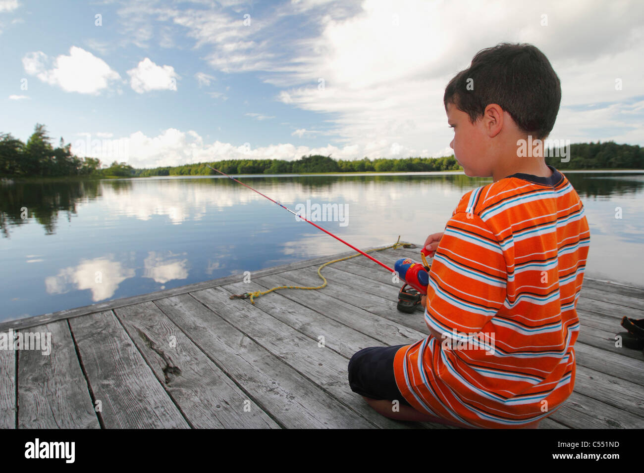 Boy bass fishing in a lake Stock Photo Alamy
