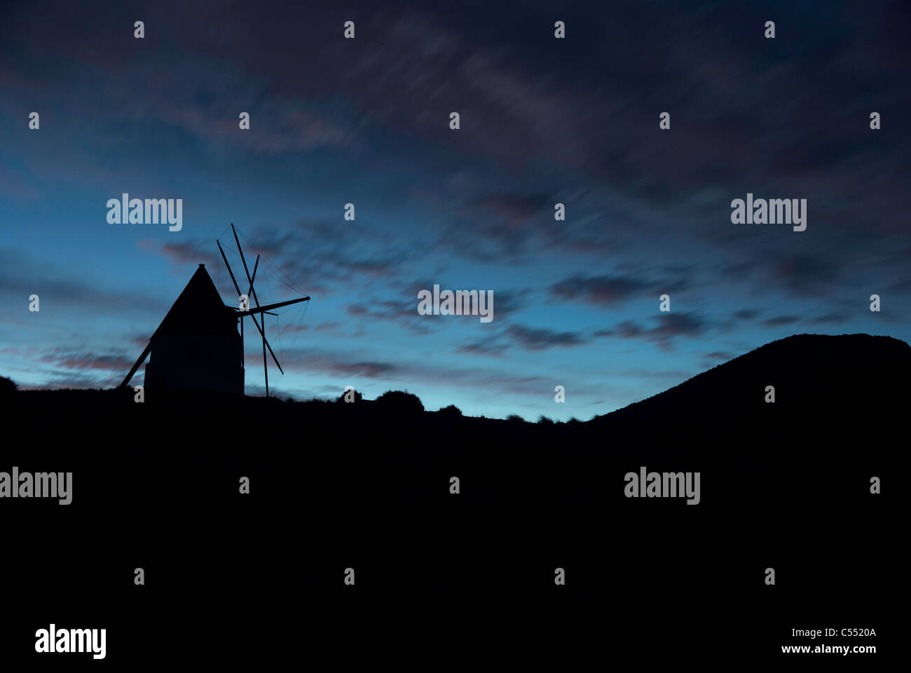 A historical windmill silhouette against dawn sky Stock Photo - Alamy
