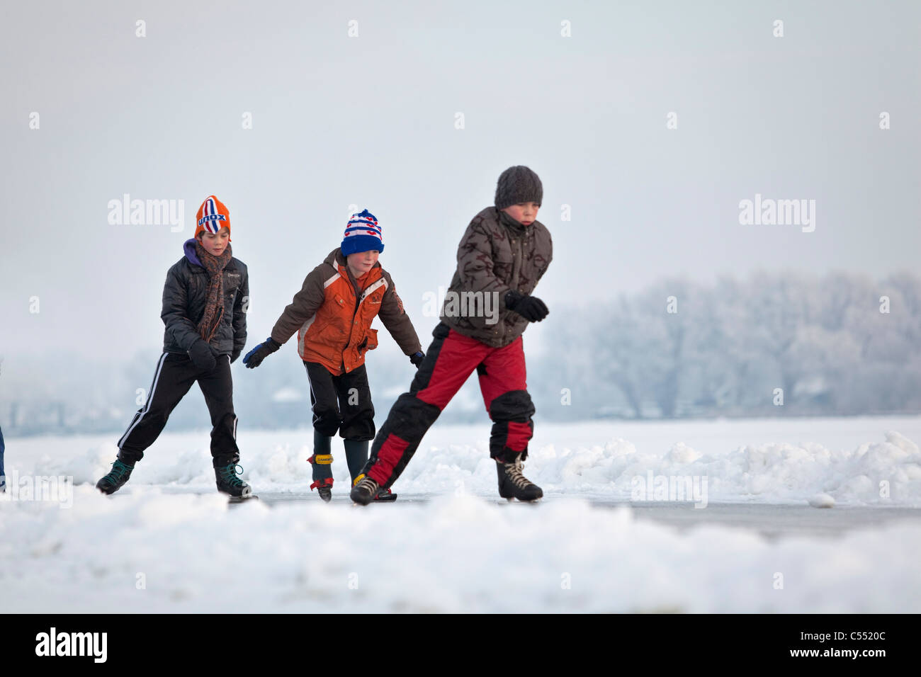 The Netherlands, Gaastmeer, Skating on frozen lake in frost and snow landscape. Stock Photo