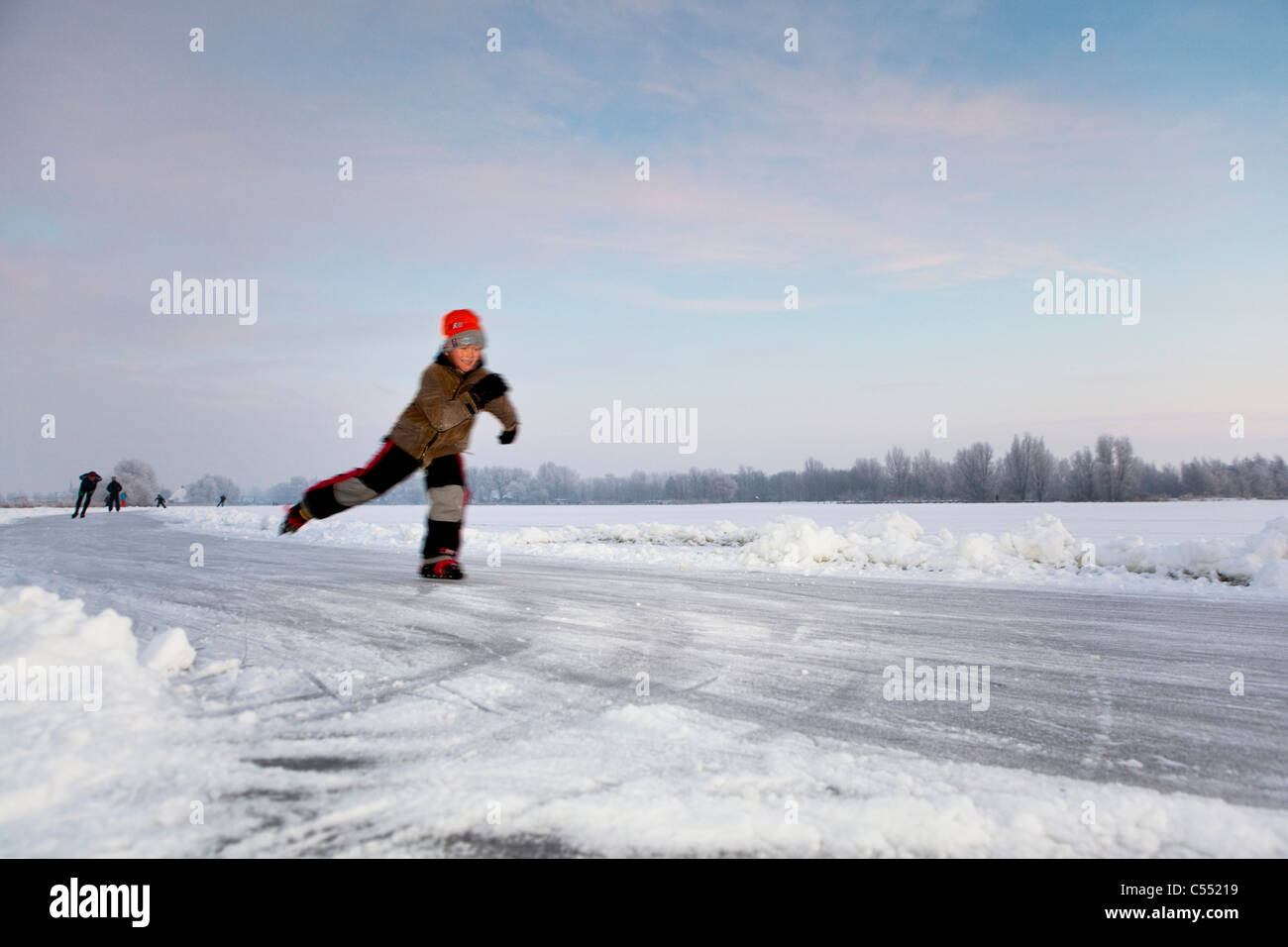 The Netherlands, Gaastmeer, Skating on frozen lake in frost and snow landscape. Stock Photo