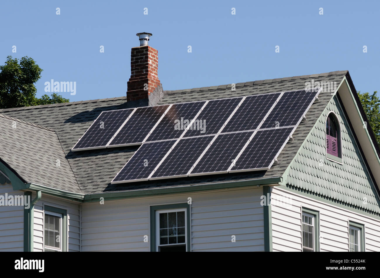 Photovoltaic solar panels on roof of  house Stock Photo