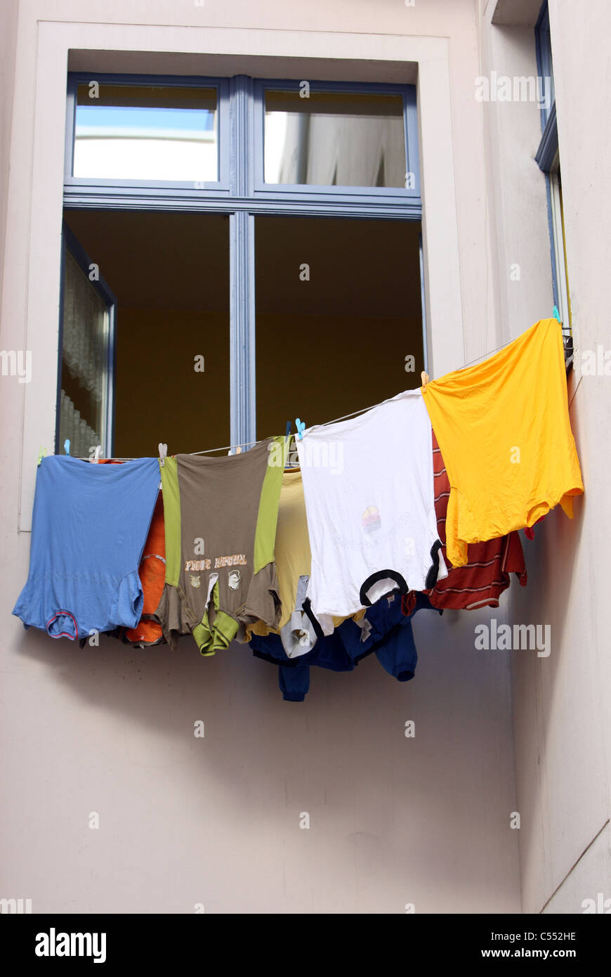 Laundry hung out to dry in front of a window Stock Photo