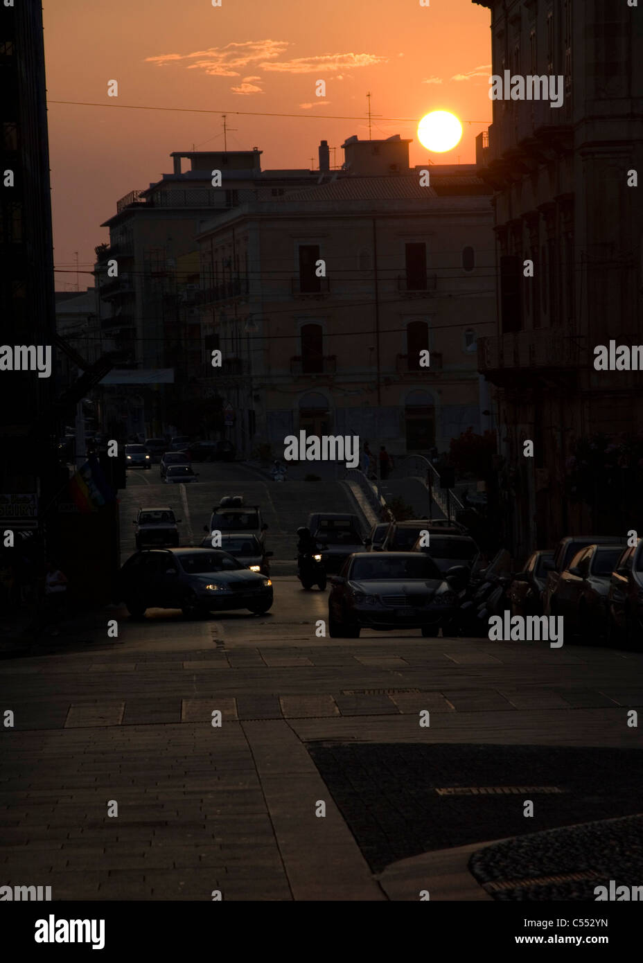 Traffic on a road at dusk, Giarre, Sicily, Italy Stock Photo