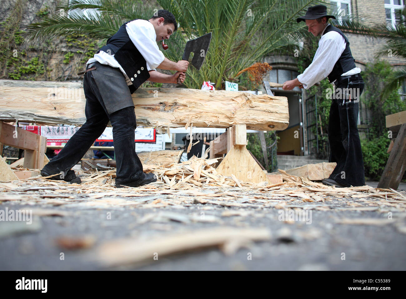Carpenters in traditional clothing at work, Berlin, Germany Stock Photo