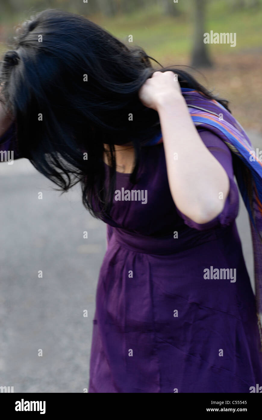 Woman in purple dress Stock Photo - Alamy