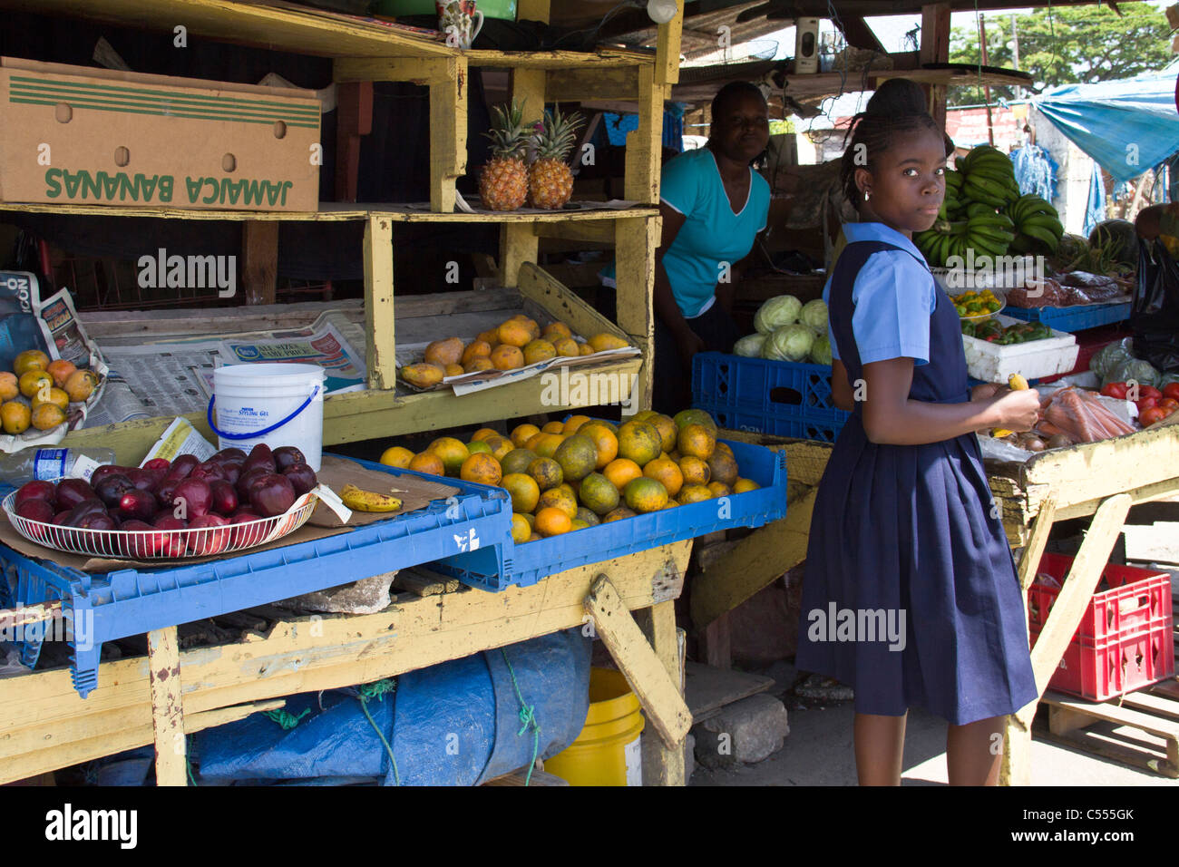 school girl shopping in Jamaican market Stock Photo