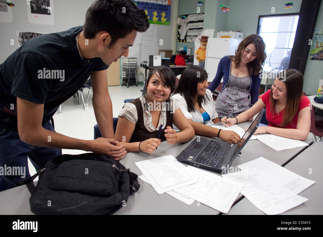 Male and female students use a laptop computer to collaborate on a class project at Mission Early College High School in El Paso Stock Photo