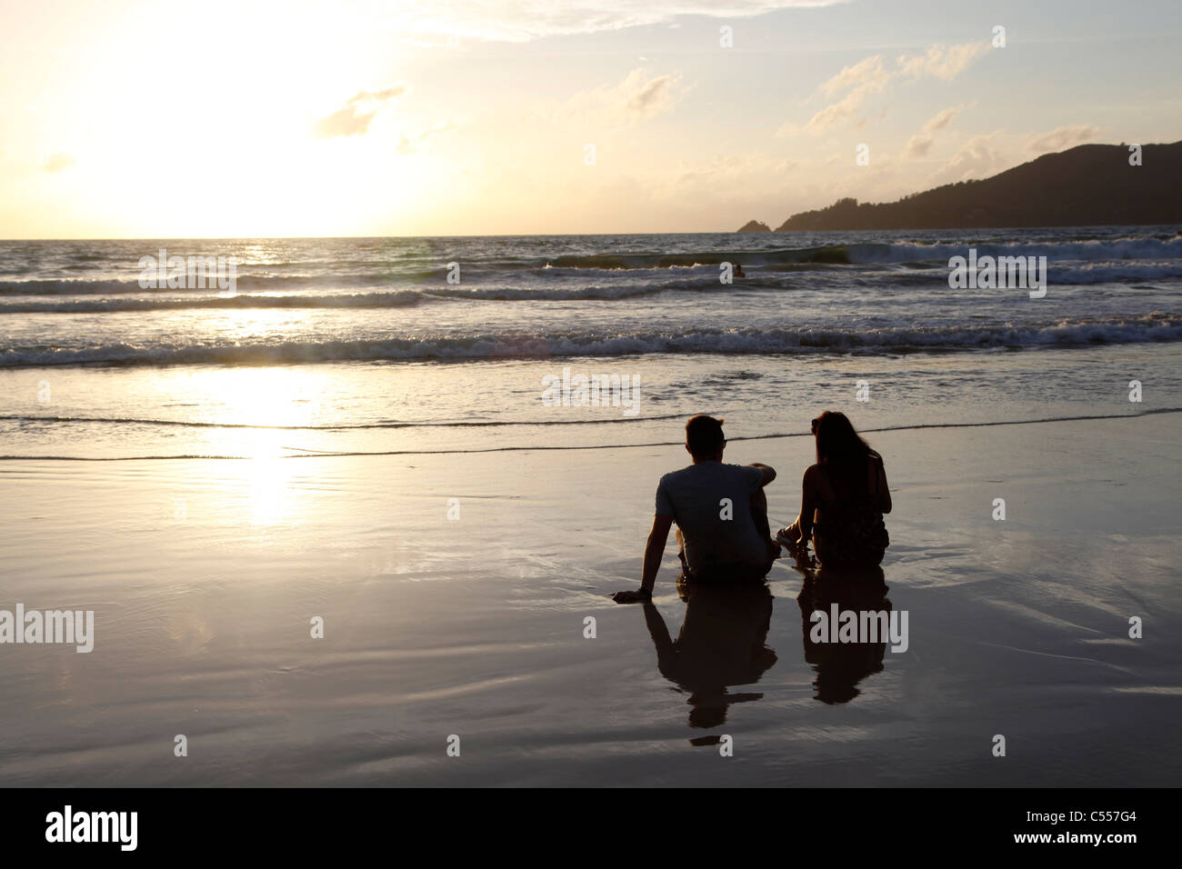 Couple watching sunset on the beach hi-res stock photography and images ...