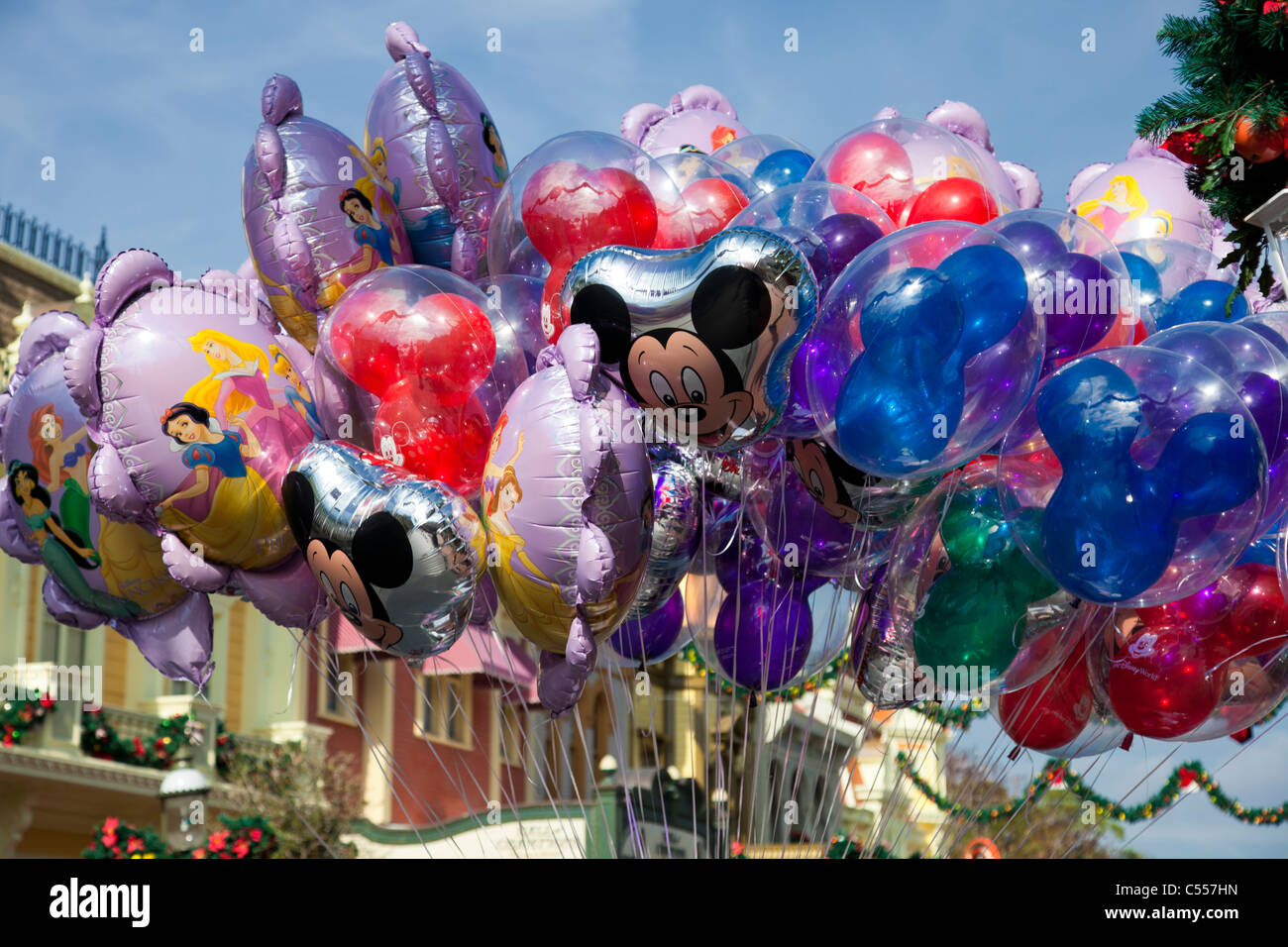 Large batch floating Character souvenir Helium Balloons on strings main street Walt Disney World Theme Park Florida Christmas decorations background Stock Photo
