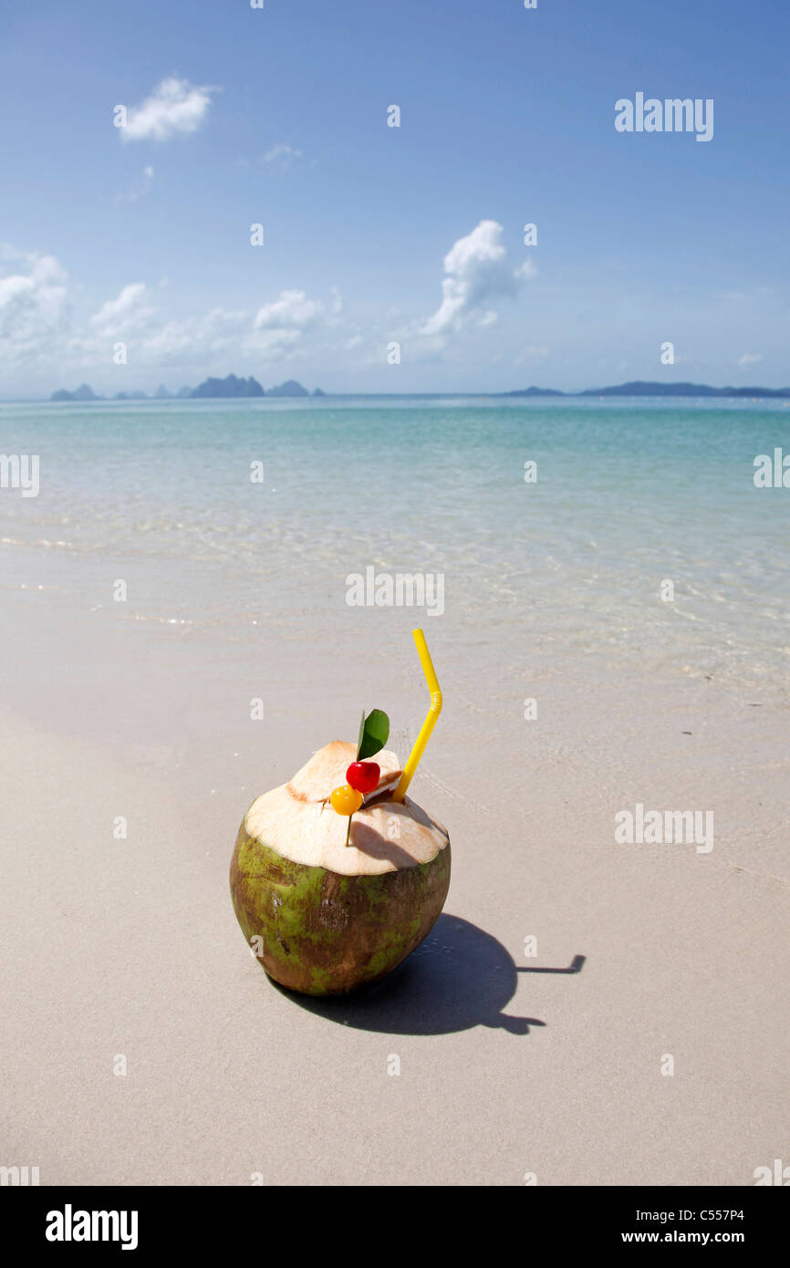 Pina Colada cocktail in a coconut on the beach in Phuket, Thailand Stock Photo