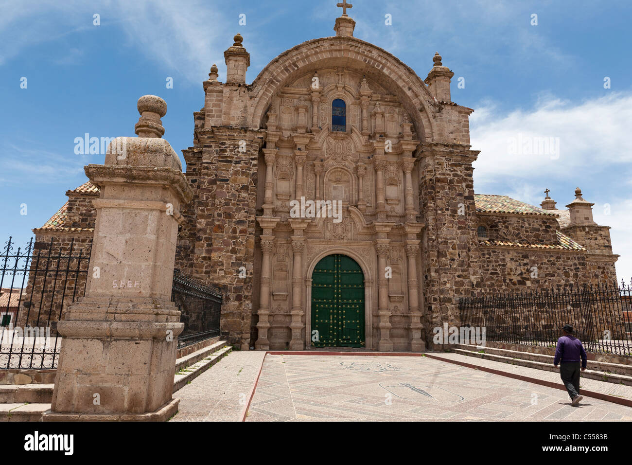 A man walks towards the facade of the church at Lampa close to Juliaca in the Peruvian Andes Stock Photo