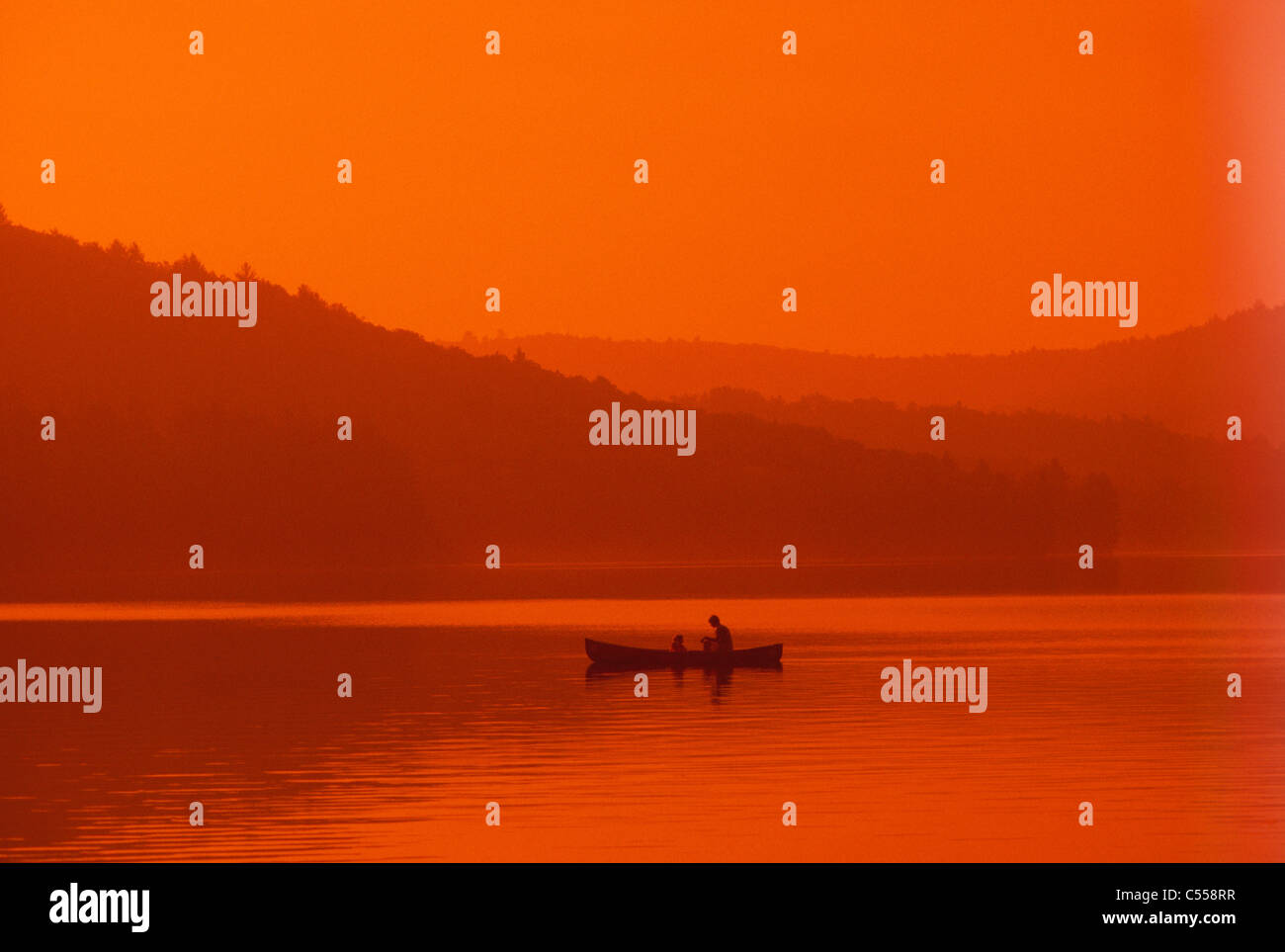 USA, Maine, Long Pond, silhouette of kayaker at dusk Stock Photo