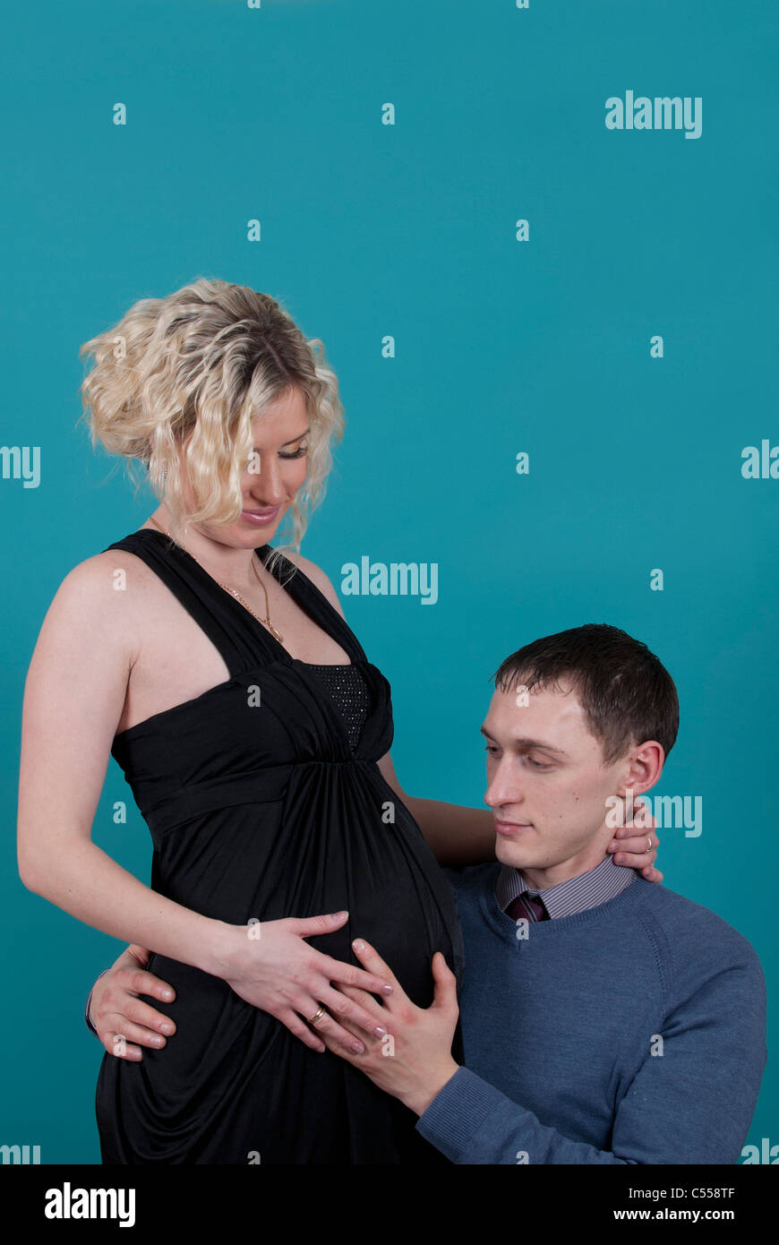 Man cuddling pregnant woman Stock Photo Alamy