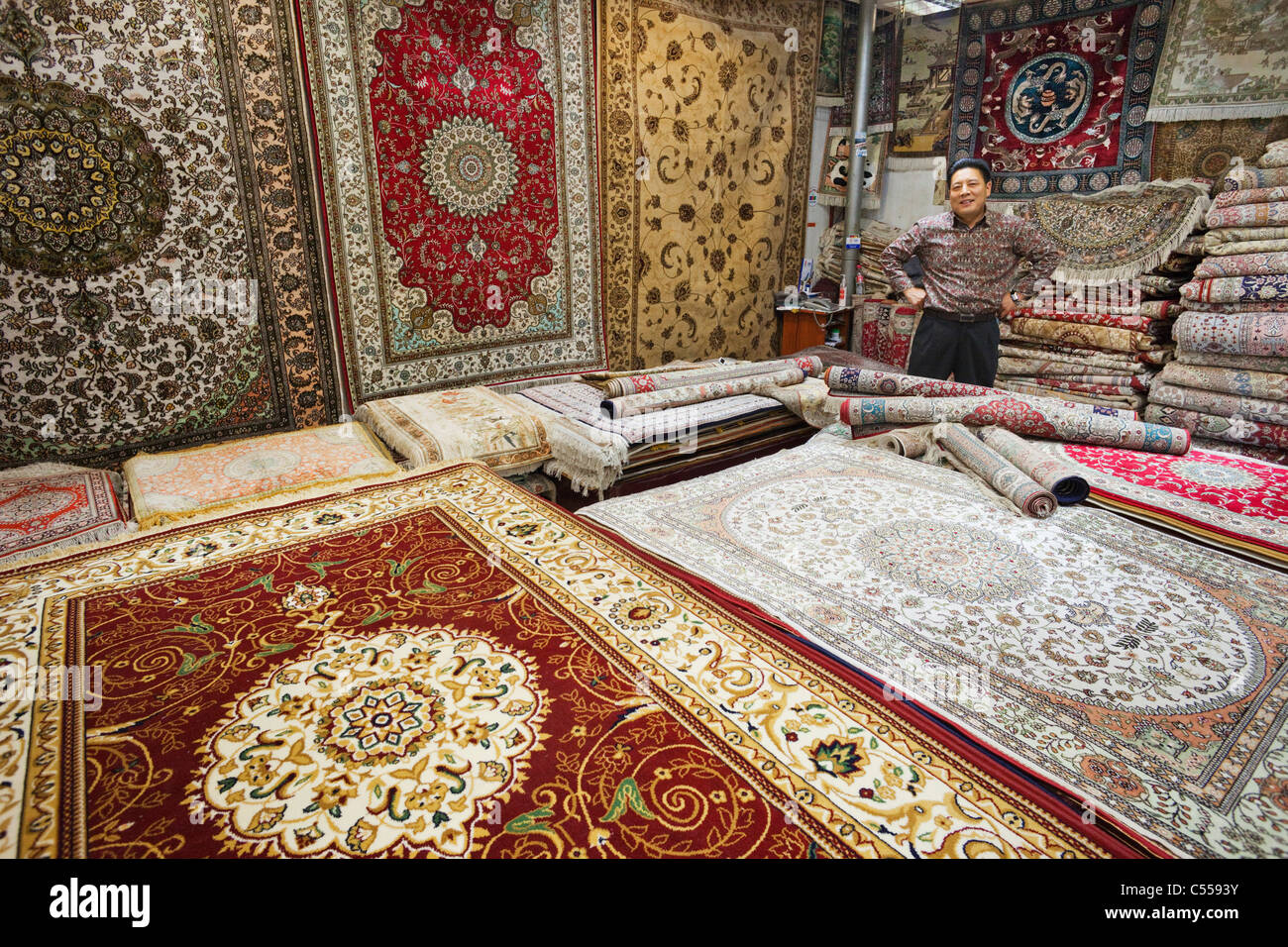 Silk carpets for sale in a store, Silk Market, Beijing, China Stock Photo