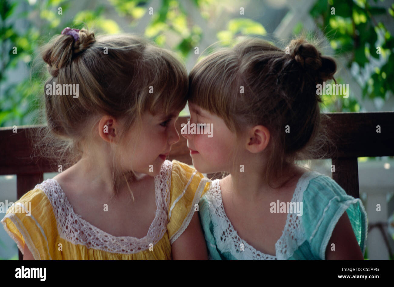 Closeup of twin girls rubbing noses Stock Photo Alamy