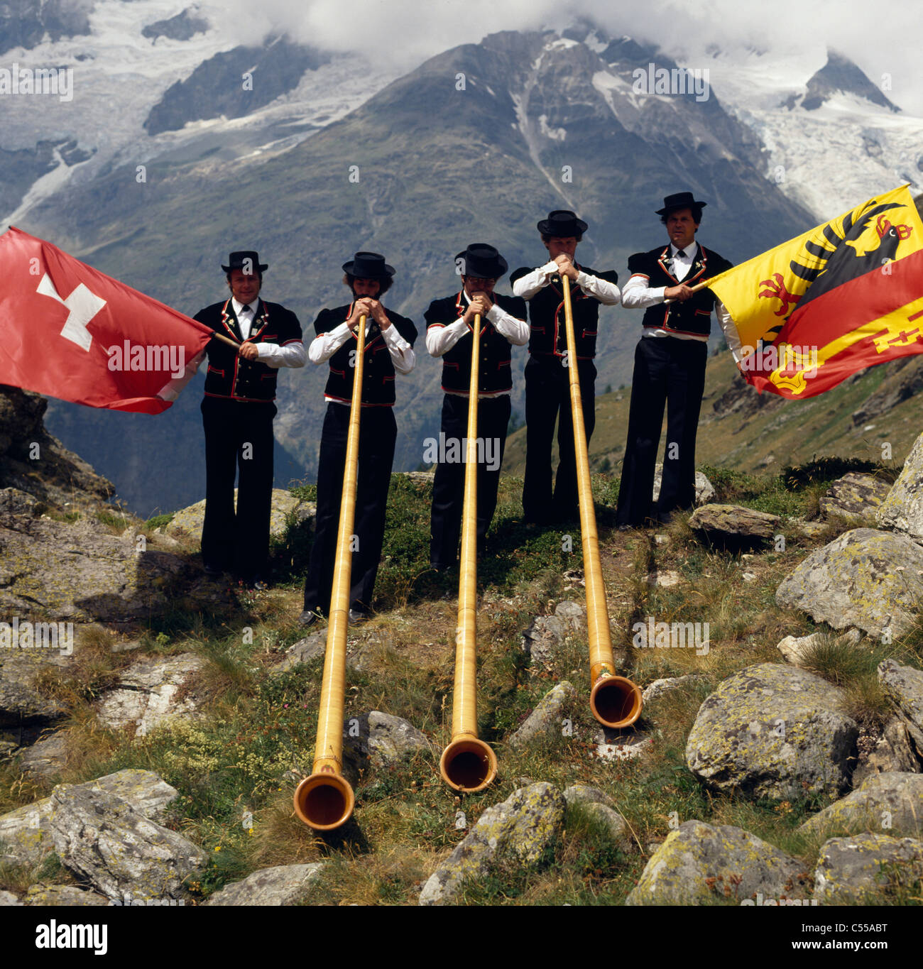 Switzerland, Valais, Taschalap, Men playing on alphorns Stock Photo