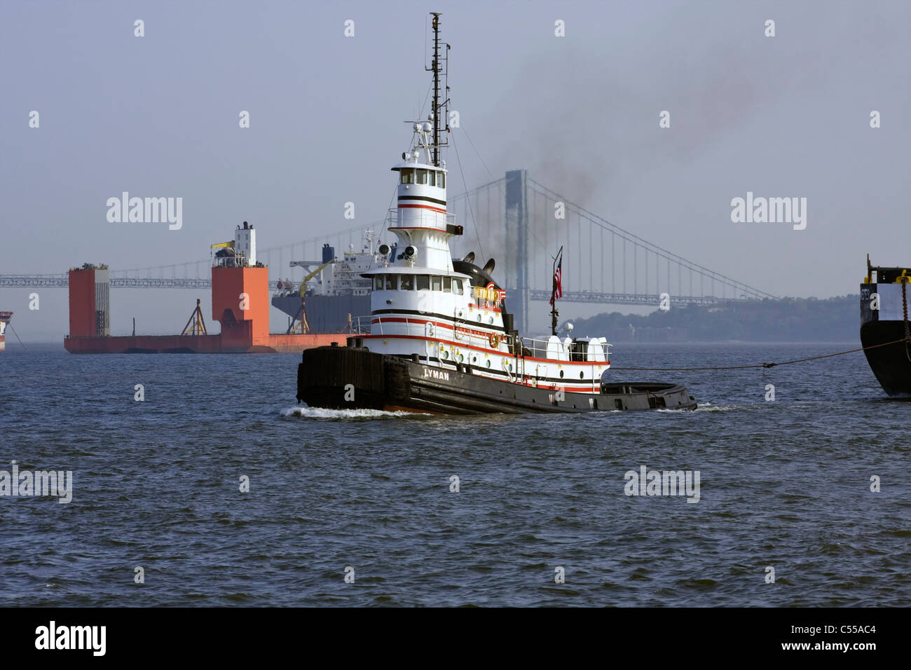 Tugboat 'LYMAN' towing a barge in New York Harbor Stock Photo